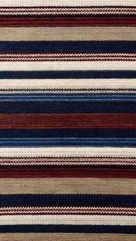 Of a closeup view of a textured fabric displaying a repeating pattern of horizontal stripes in various colors including blue, red, beige, and white photo