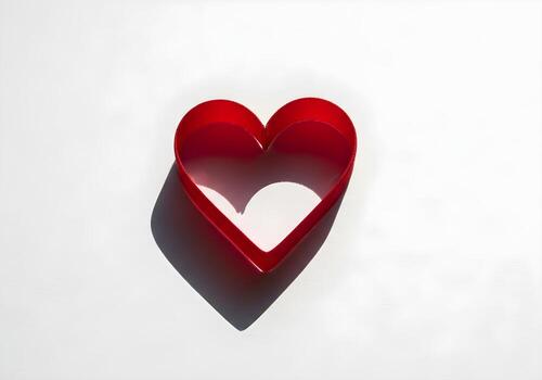 Red Velvet Ribbon Heart on White Textured Paper photo