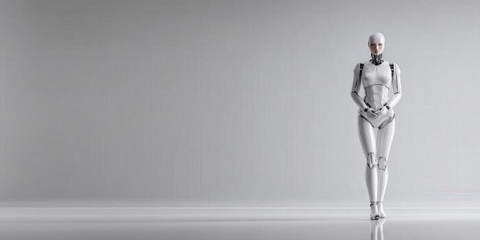 A white robot standing in front of a gray background photo