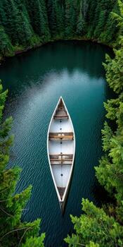 A boat floating in a lake surrounded by trees photo