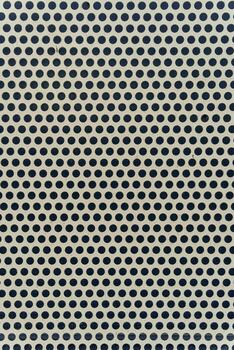 A perforated metal surface with evenly spaced circular holes showcases precision and minimalism in industrial design. The geometry and rhythm of the shapes form a visually appealing technical pattern. photo