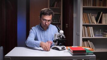 Scientist counting coins in university library with microscope video