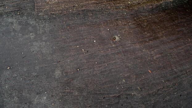 Above view 1.of dark black and brown stone slabs. Different patterns create beauty. Wet surface. For background and textured. photo