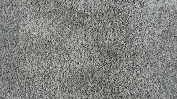 Abstract grey textured background showing a rough grainy surface. Excellent for minimalist designs, backdrops or to add subtle depth. photo