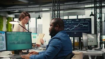 Woman secretary in an office pushes a trolley filled with paperwork and reports, bringing files to a colleague and ensuring efficient distribution of resources. Administrative tasks. Camera A. video