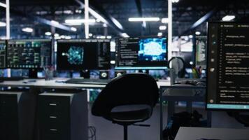Computers in data center supporting AI training workflows and automated infrastructure systems. PC screens in high tech facility tracking servers hardware processing machine learning datasets video