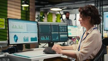 Administrator engages with financial data insights on a computer, developing innovative business solutions and aligning project goals with company objectives. Corporate environment. Camera A. video