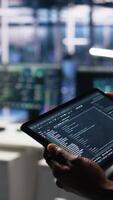 vertical fechar acima do dados Centro Programas desenvolvedor usando tábua para Reveja código para automação scripts. servidor cubo isto especialista usando dispositivo, monitoramento erro Histórico para depuração processos, Câmera uma video