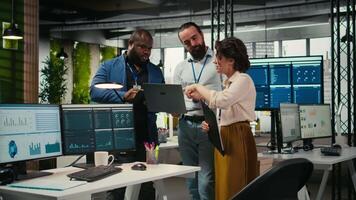 team av kontor arbetare samarbetande på projekt planera och genomgång, använder sig av data från diagram på läsplatta till kör prestanda metrik. främja lagarbete och en arbetsplats partnerskap. kamera a. video