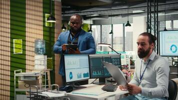 Black consultant leverages analytics and report writing for forecast results and corporate development, utilizing digital resources and insights for strategic alignment with goals. Camera A. video