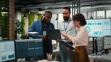 Diverse group of employees collaborate on project planning and analysis, using data from charts on tablet to drive performance metrics. Fostering teamwork and a workplace alliance. Camera A. video