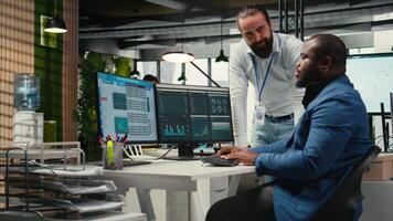 Diverse corporate team focuses on data management on computer, planning strategies for company growth and aligning objectives with performance metrics for measurable productivity. Camera A. video