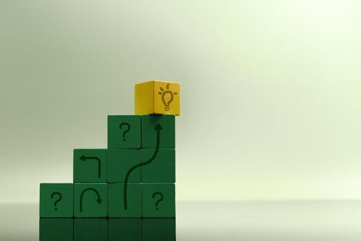 Staircase of green blocks with question marks leads to yellow cube symbolizing a solution, problem-solving, innovation and economic recovery photo