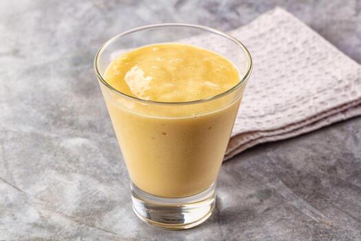 A smoothie in a glass on a table photo