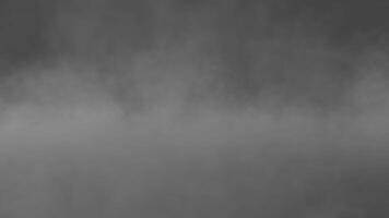 Enigmatic Fogscape, Atmospheric fog blankets a landscape, its texture and depth creating a scene of mystery and tranquility. A minimalist monochromatic depiction of the world obscured by the weather video