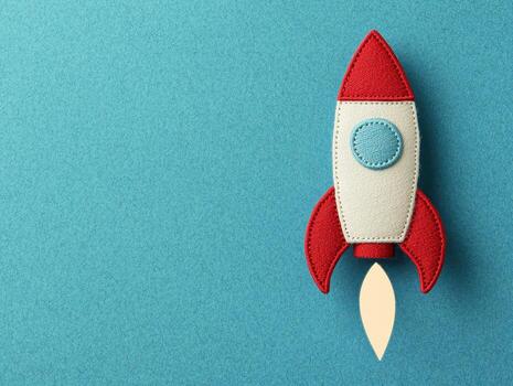 Colorful rocket shaped patch with flame blue background photo