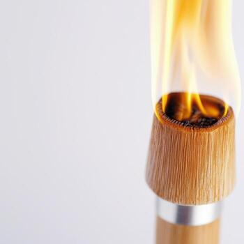 Closeup of burning torch flame on white background photo