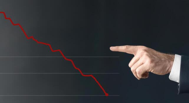 Business downtrend graph with pointing hand showing decline photo