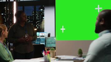 Diverse team in a dark office shares insights and exchanges feedback, finalizing company agenda during a project briefing with global stakeholders. After hours discussion. Camera B. video