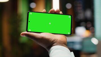 Team members meeting after hours next to isolated smartphone screen, attending an advisory board briefing session to build a strategy and setting goals for project agenda. Camera A. video