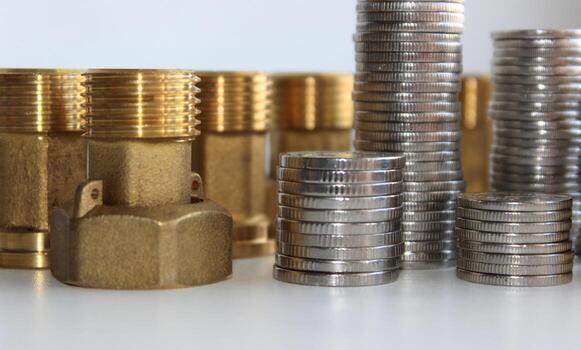 Male Brass Water Meter Fittings And Union Nuts With Columns Of Variety Coins In A Columns Closeup View photo