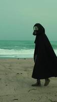 A Man In A Cloak And Gas Mask Walks On A Radiation Poisoned Beach video