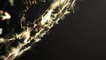 vibrerande och organisk strömma av lysande gyllene partiklar skapande abstrakt, rökliknande mönster och dynamisk visuell effekter mot en mörk bakgrund. video