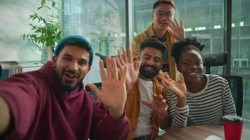 Four diversity colleagues startup workers in office multiracial informal business team happy talking smiling greeting to vlog call welcome come here conference mobile phone web cam point of view video