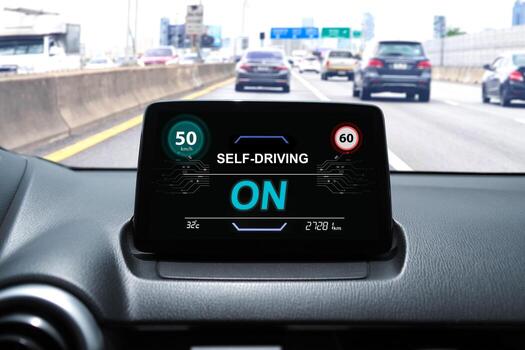 Self-driving car dashboard display with speed limit alert and active autonomous driving mode on highway photo