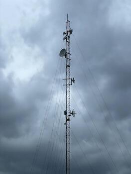 Urban Sky with Cell Tower - Symbol of Modern Communication and Digital Age. photo