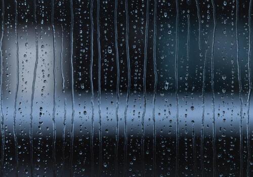 gotas de lluvia en un ventana vaso con un borroso antecedentes foto