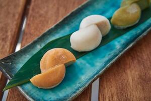 Deliciously Crafted Japanese Mochi Varieties on a Beautiful Plate with Leaves, Showcasing Unique Colors and Textures of This Traditional Dessert photo
