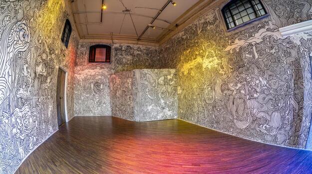 Of an artfilled room with doodle patterns covering the walls and floor photo