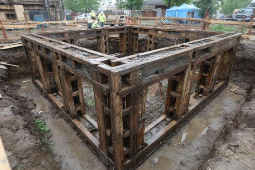 A wooden structure is being built in the mud photo