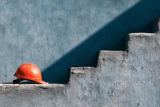 A construction helmet sitting on a stair photo