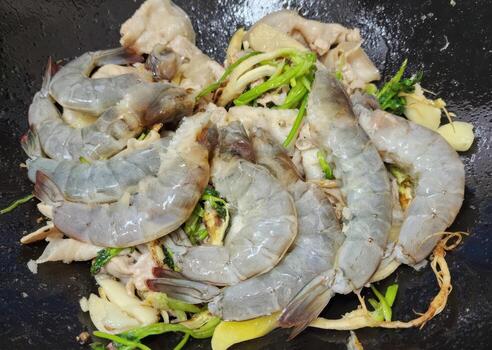Stir-fried Shrimp and Chicken with Vegetables in a Wok photo
