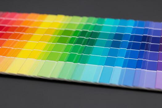 Vibrant Spectrum A Close-Up of a Colorful Paint Chip Gradient, showcasing a smooth transition of hues from red to violet against a dark background. photo