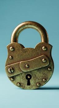 An old brass padlock with a keyhole on a blue background photo