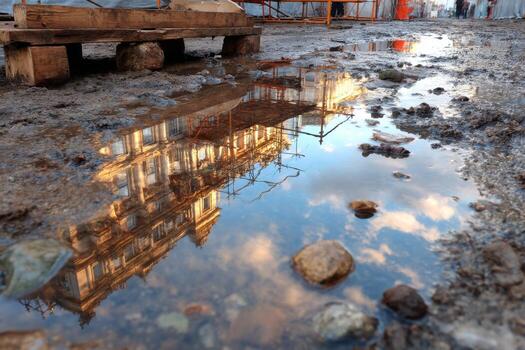 A puddle of water with a building reflected in it photo