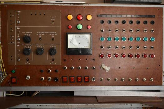 An old control board with a voltmeter, switches and lamps. Electronic control panel with buttons and toggle switches. The old management system. photo
