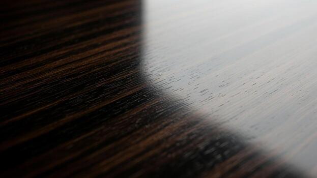 A close up of a wooden table with a black surface photo