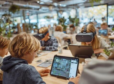 Elementary school students using virtual reality headsets and tablets in modern classroom photo