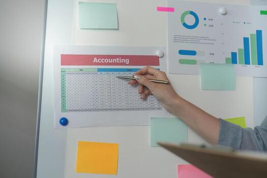 Accounting Overview. Hand pointing at financial data on a presentation board. photo