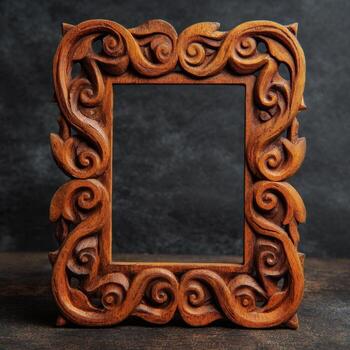 Wooden frame with scroll design on dark background photo