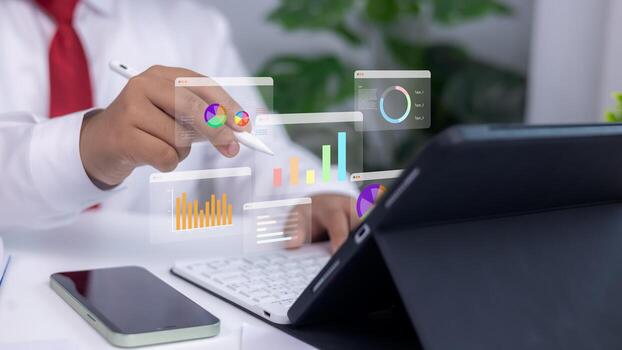 Analytics dashboards and floating holographic charts displayed as a person uses a stylus on a tablet. Concept of modern business analysis, financial planning, and data-driven technology photo