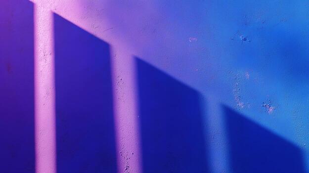 Shadows create a striking pattern on a textured wall in vibrant purple and blue tones during late afternoon light photo