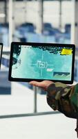 Vertical Close up of army general and coworker in data center integrating AI into radar systems for missile tracking. Teamworking soldier and technician in server hub analyzing aerial movement on device, camera B video