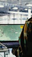 vertikal armén specialist i data Centrum integrering ai in i radar system för missil spårning. militär soldat i server rum analyserar antenn rörelse genom artificiell intelligens system, kamera b video
