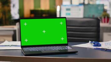 Empty office boardroom space with a laptop running copy space display, workspace used for performance reports and documents planning. Organization committed to business growth and success. video
