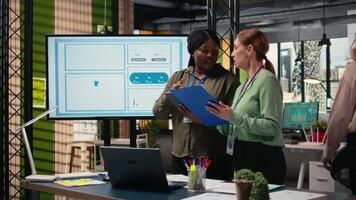 Collaborative team of professional women reviews key data and reports while setting strategy for business growth, aligning insights with development goals and teamwork. Networking. Camera A. video